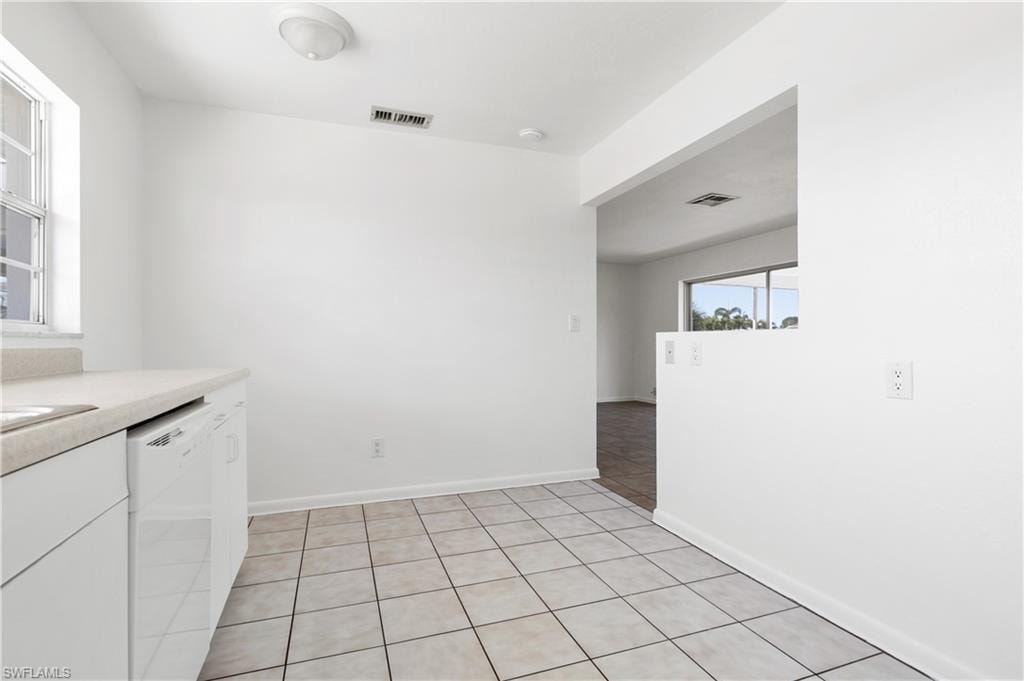 Kitchen with dishwasher and light tile patterned floors
