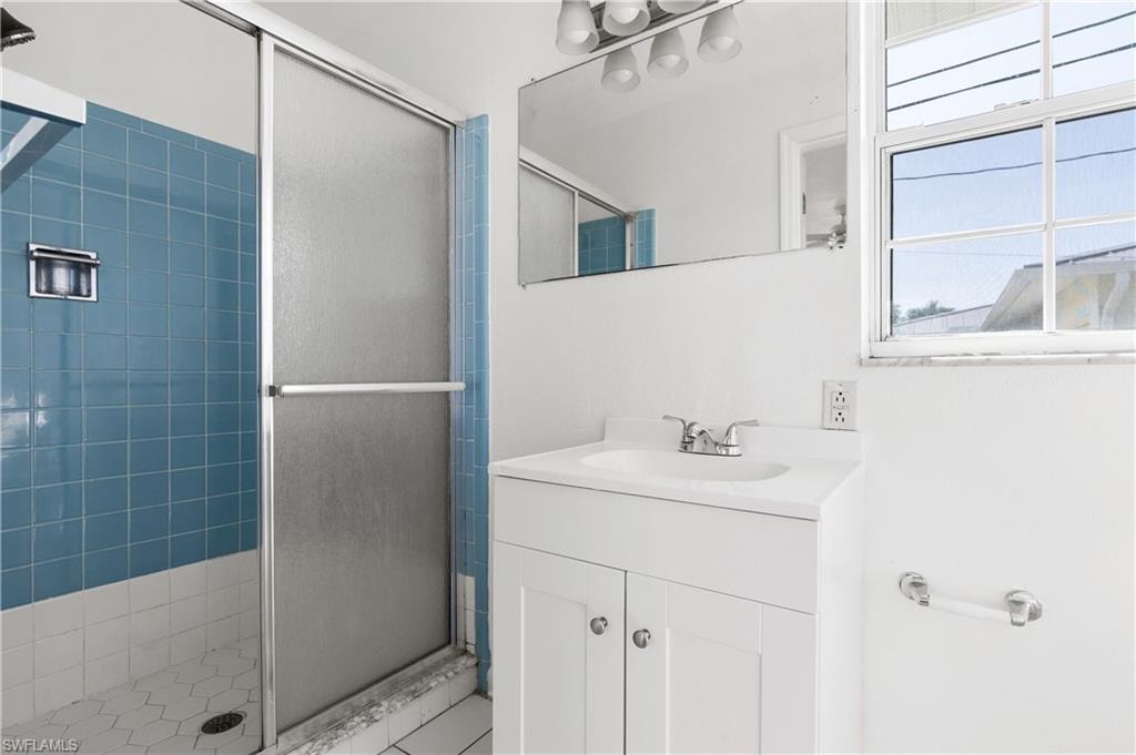 Bathroom featuring walk in shower and vanity