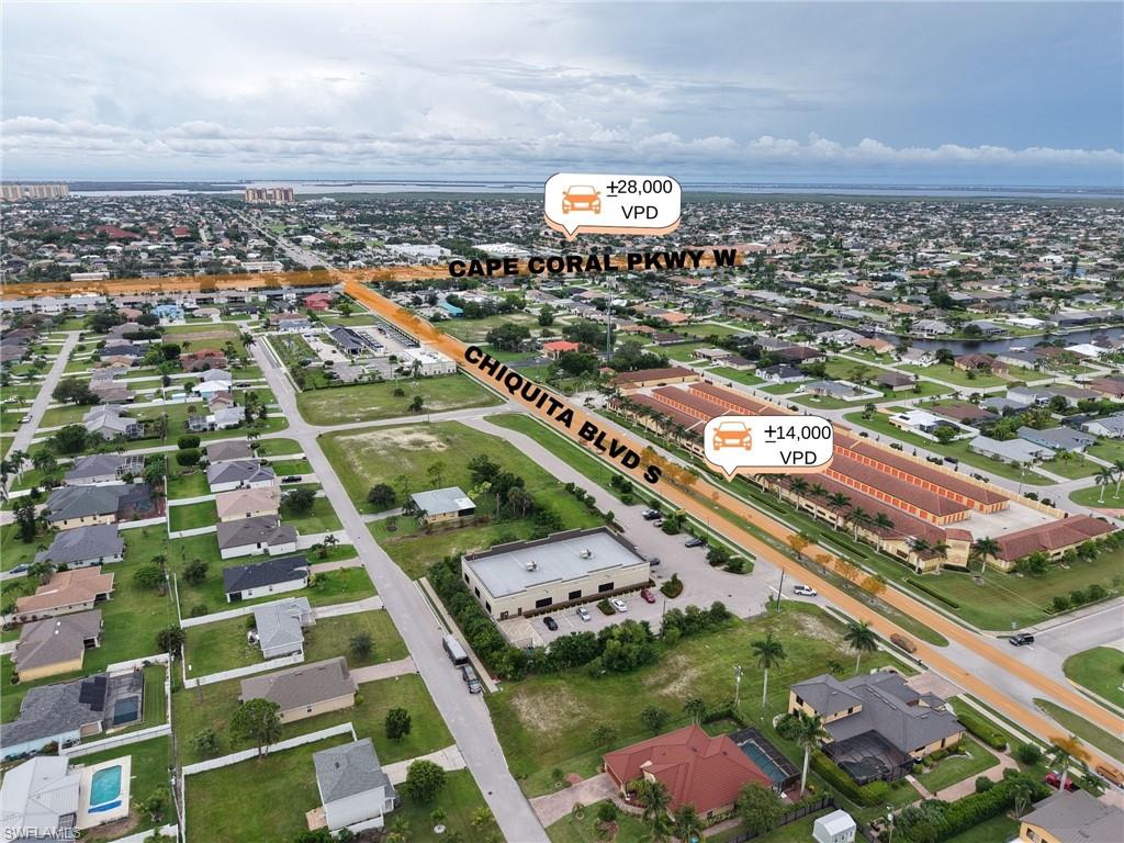 Aerial view of property's location with nearby suburban area