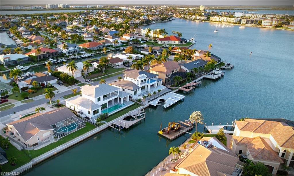 Aerial view of residential area featuring a nearby body of water