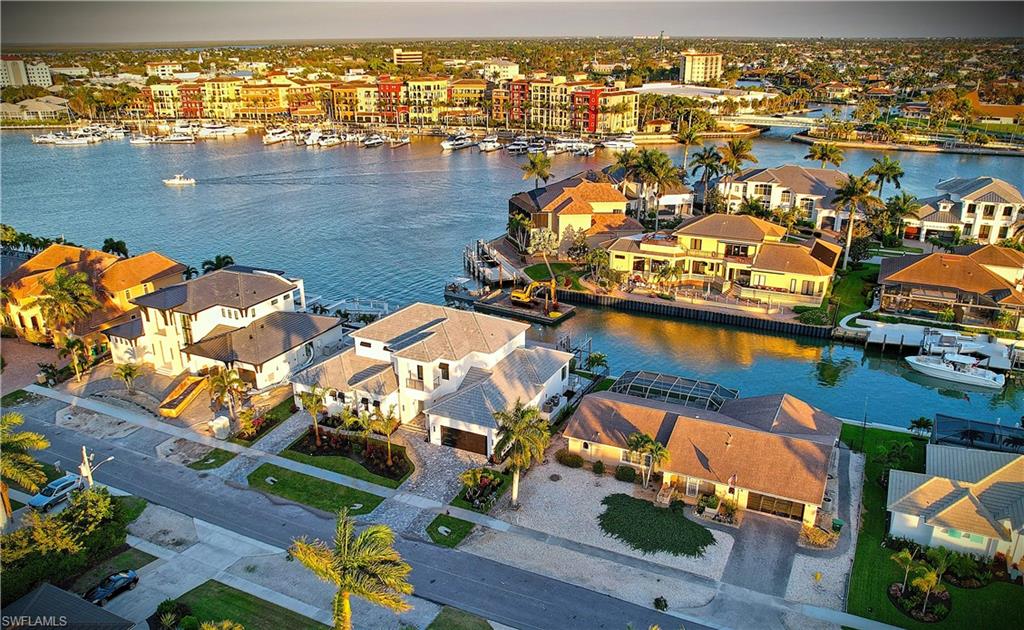 Aerial view of residential area featuring a nearby body of water
