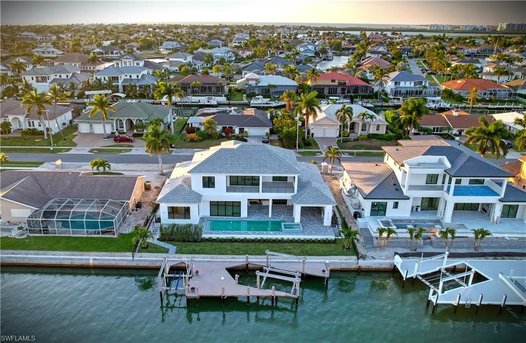 Aerial perspective of suburban area with a large body of water