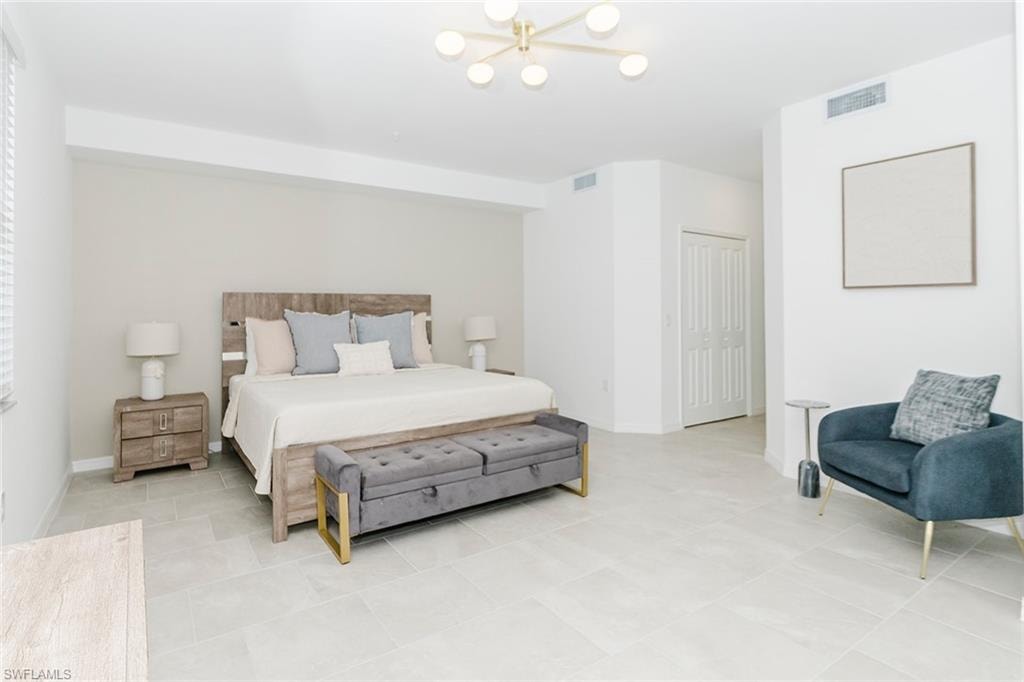 Bedroom featuring suspended lighting and baseboards
