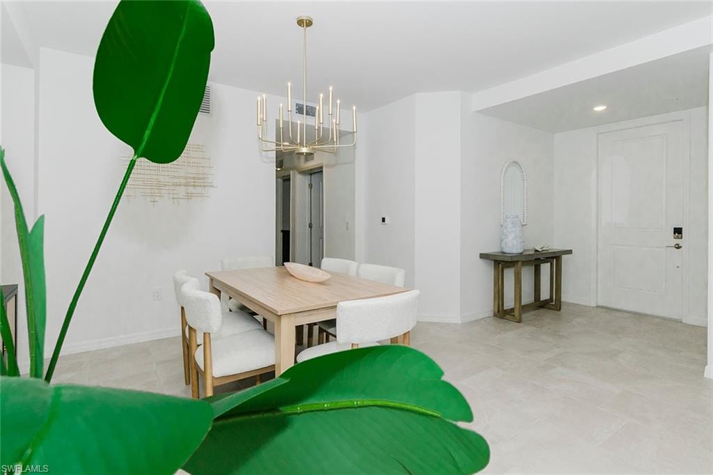 Dining space featuring a chandelier and baseboards
