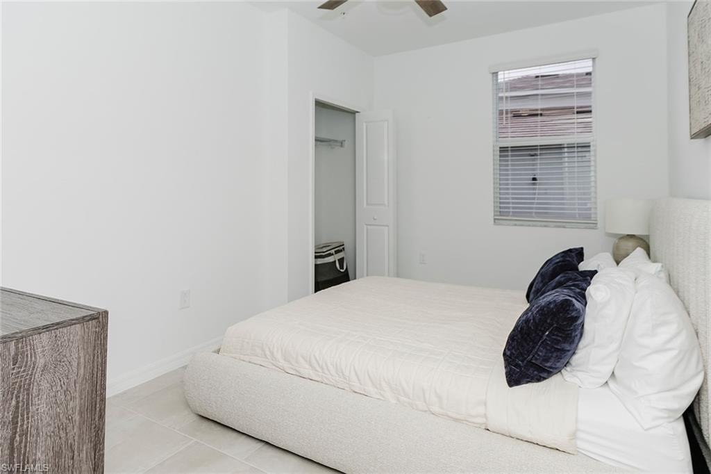 Bedroom with a ceiling fan and light tile patterned floors
