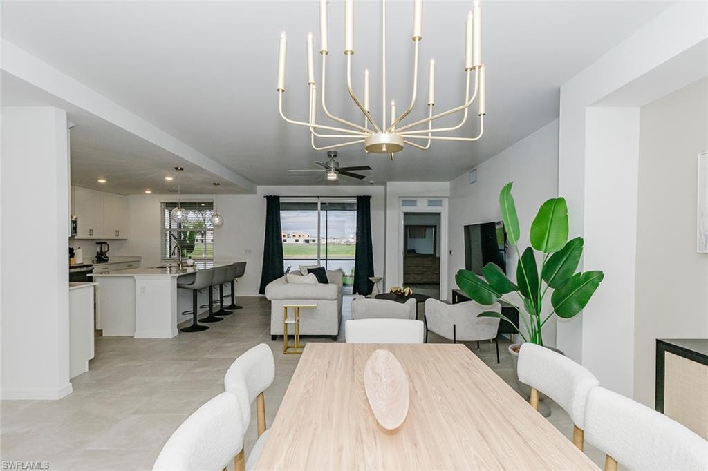 Dining space featuring suspended lighting and ceiling fan