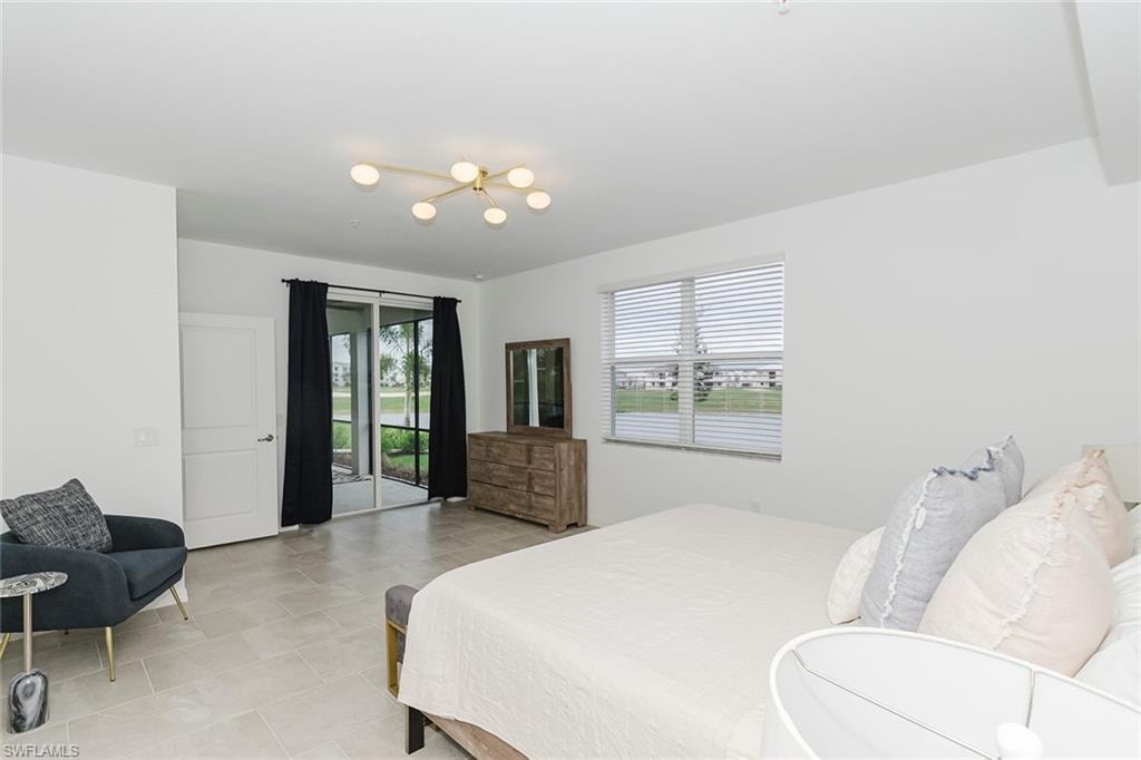 Bedroom with multiple windows and access to exterior