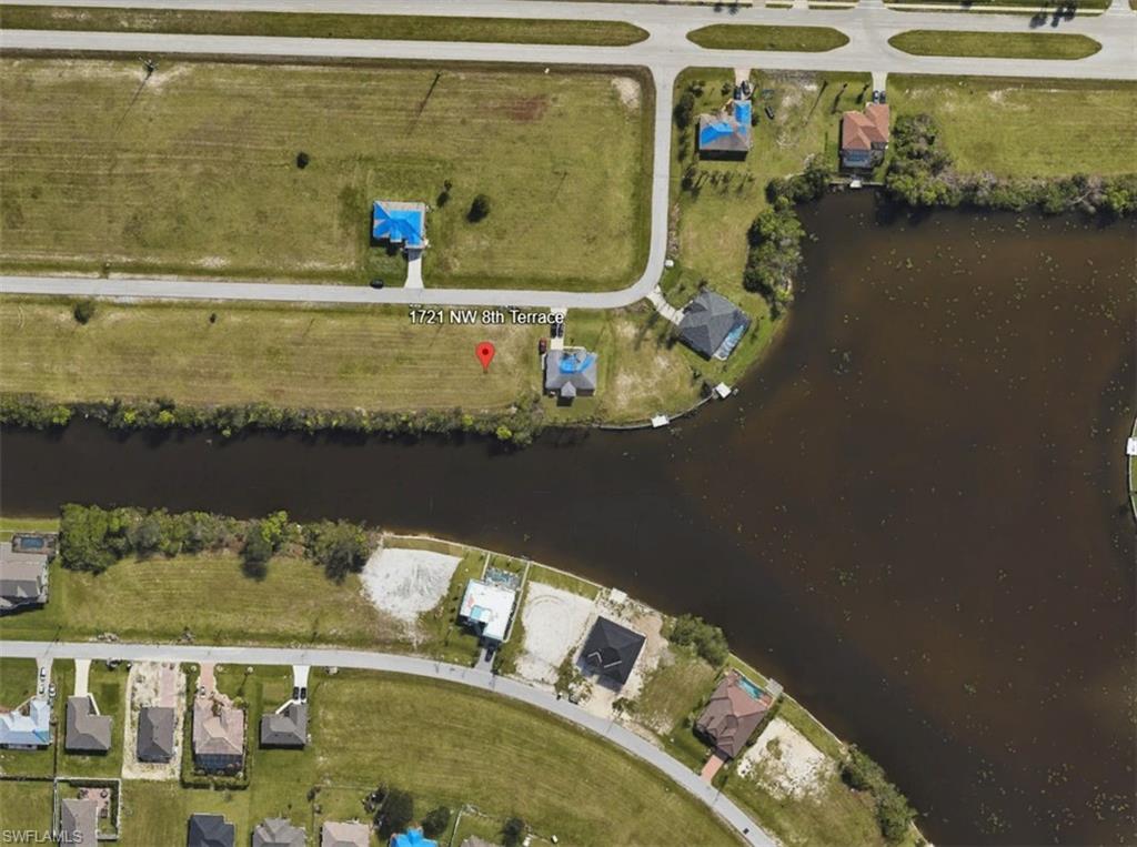 View of property location featuring a nearby body of water and nearby suburban area