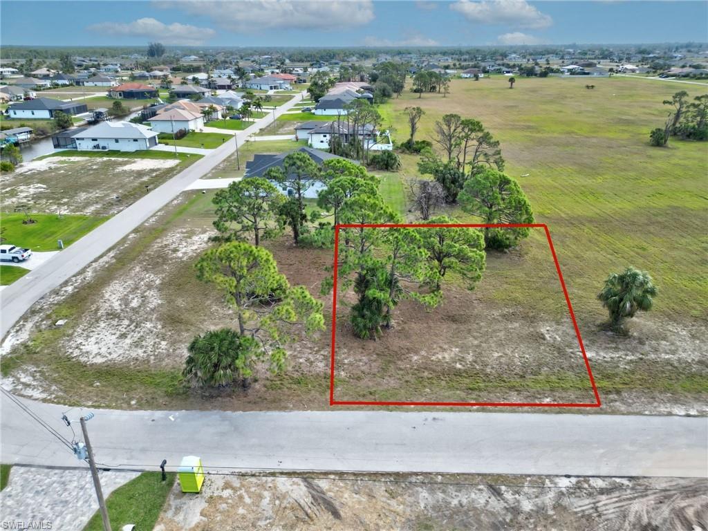 Aerial view of property and surrounding area featuring property parcel outlined