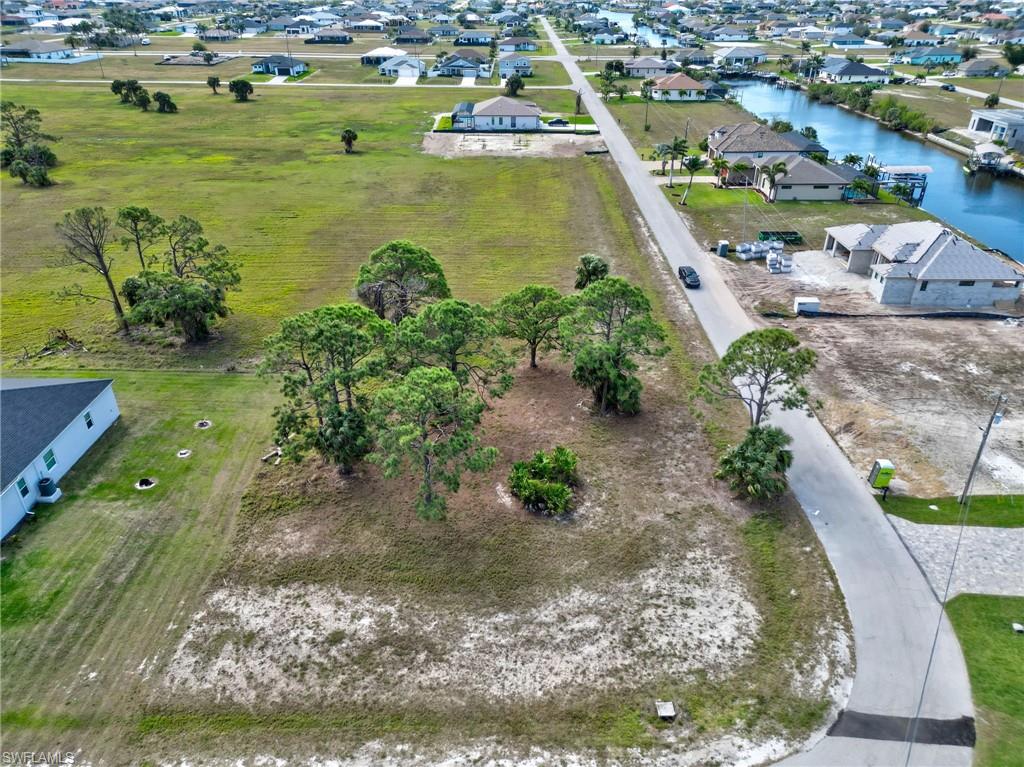 Aerial view of property and surrounding area featuring nearby suburban area