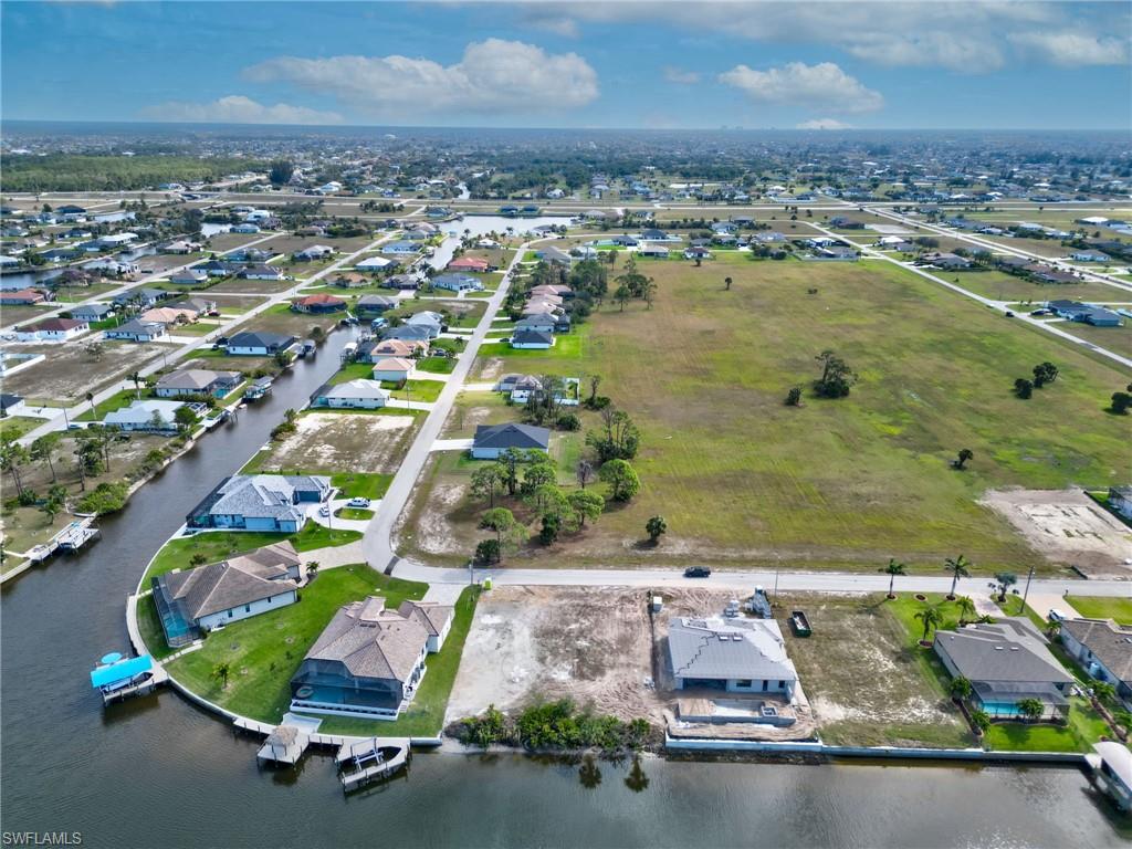 View of property location with nearby suburban area and a nearby body of water