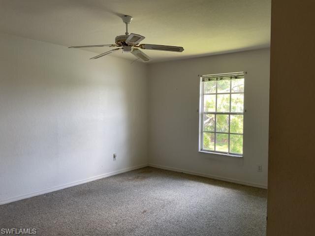 Spare room with carpet flooring and ceiling fan