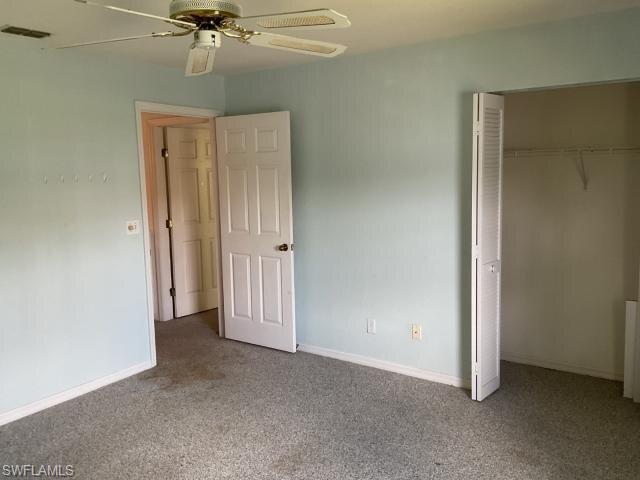 Unfurnished bedroom featuring carpet, a closet, and ceiling fan