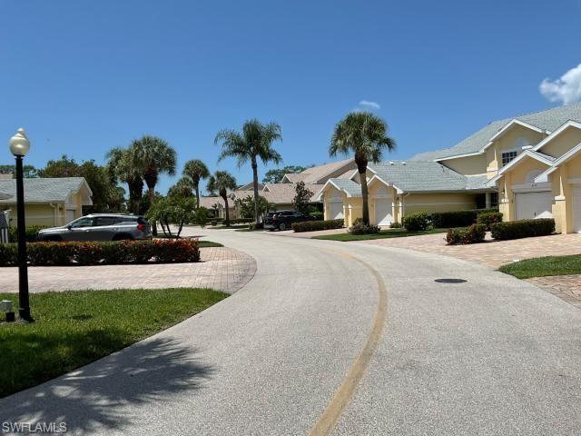 View of asphalt street featuring street lighting and a residential view