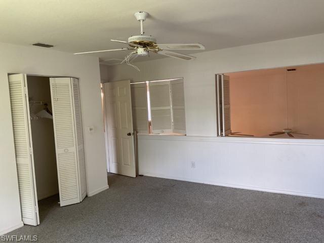 Unfurnished bedroom with a closet, carpet floors, and ceiling fan