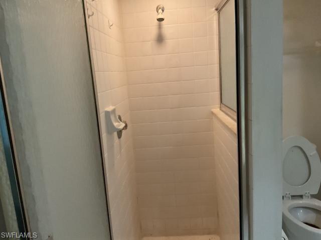 Bathroom with toilet and a stall shower