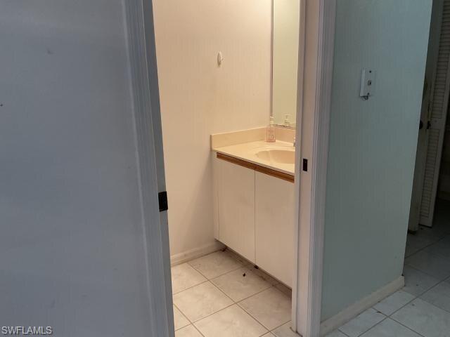 Bathroom with vanity and light tile patterned flooring