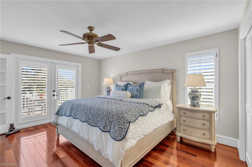 Bedroom featuring access to outside, wood finished floors, a ceiling fan, and a closet