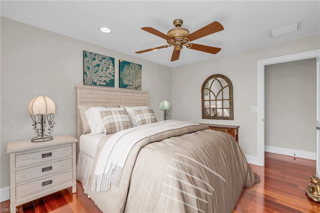 Bedroom featuring dark wood-style flooring, a ceiling fan, and recessed lighting