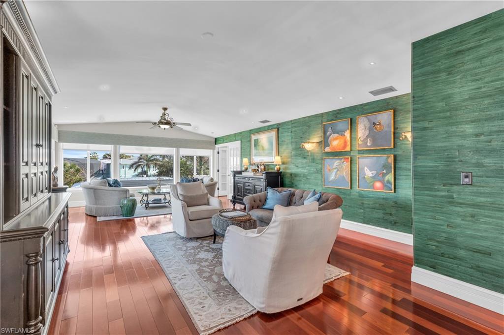 Living room with lofted ceiling, dark wood-style floors, a ceiling fan, and recessed lighting