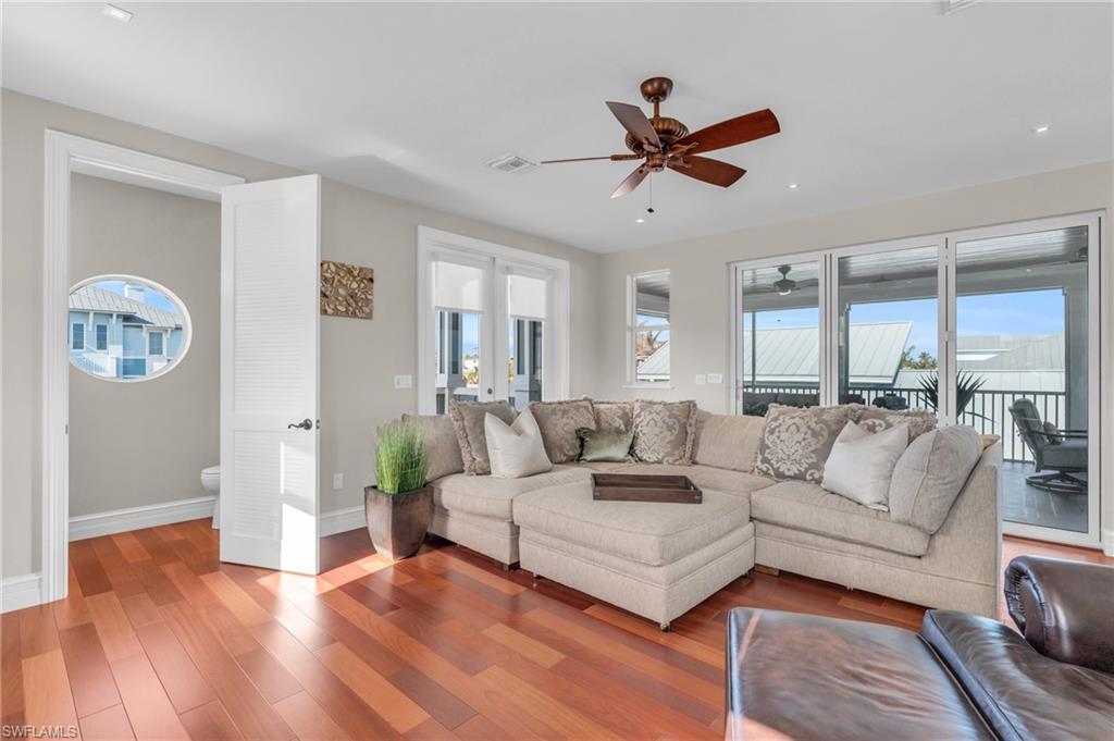 Living room featuring wood finished floors, ceiling fan, and french doors