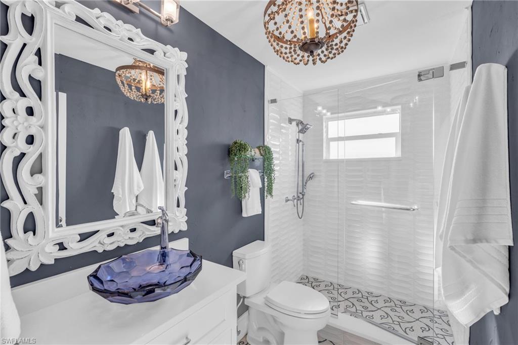 Full bath featuring a shower stall and vanity