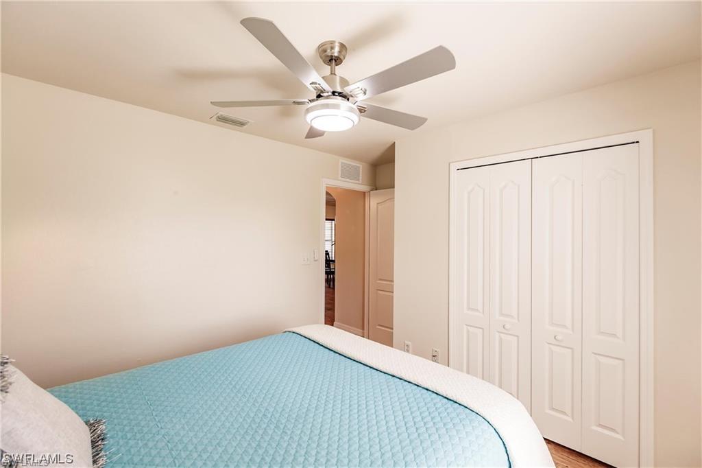Bedroom with ceiling fan and a closet