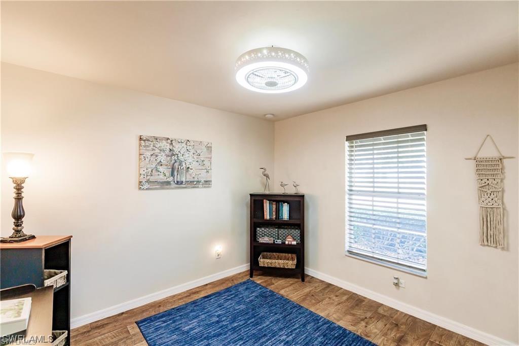 Sitting room with baseboards and wood finished floors