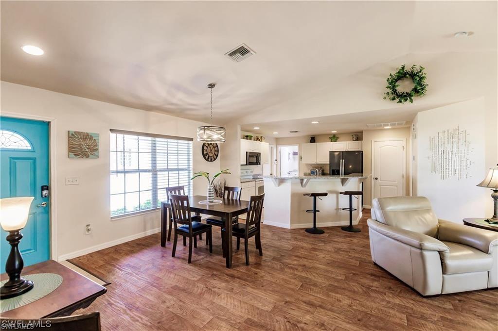 Dining area featuring recessed lighting and dark wood-style floors