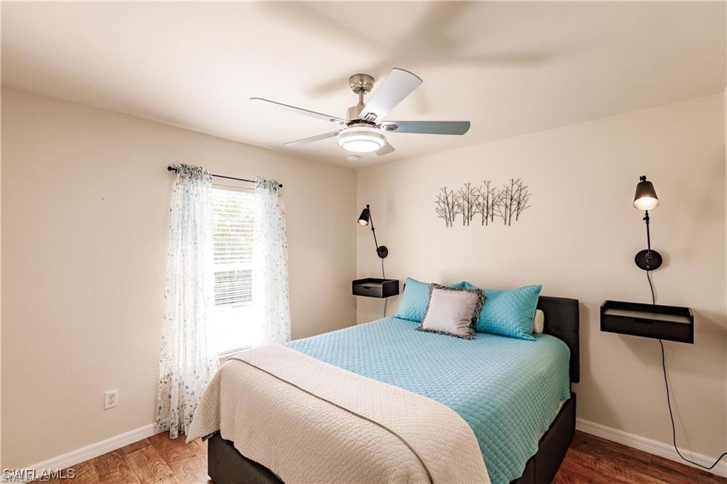 Bedroom with wood finished floors and ceiling fan