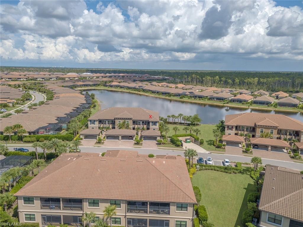 Aerial perspective of suburban area featuring a large body of water