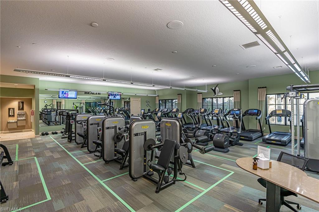 Workout area featuring carpet floors and a textured ceiling