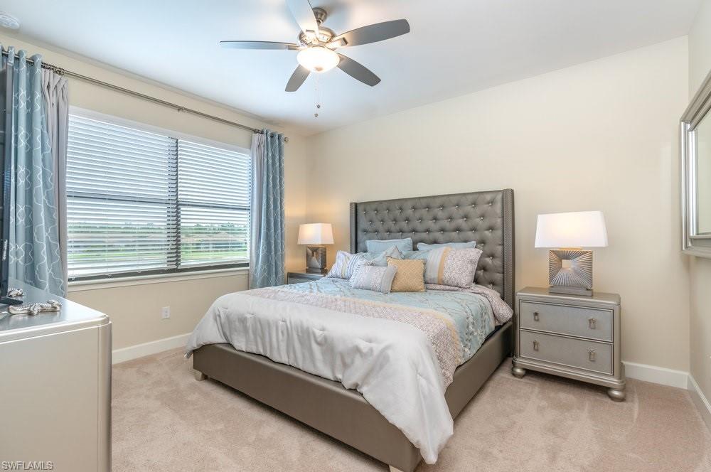 Bedroom featuring light colored carpet and ceiling fan