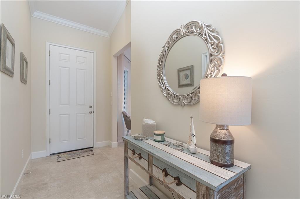 Entryway with baseboards and ornamental molding