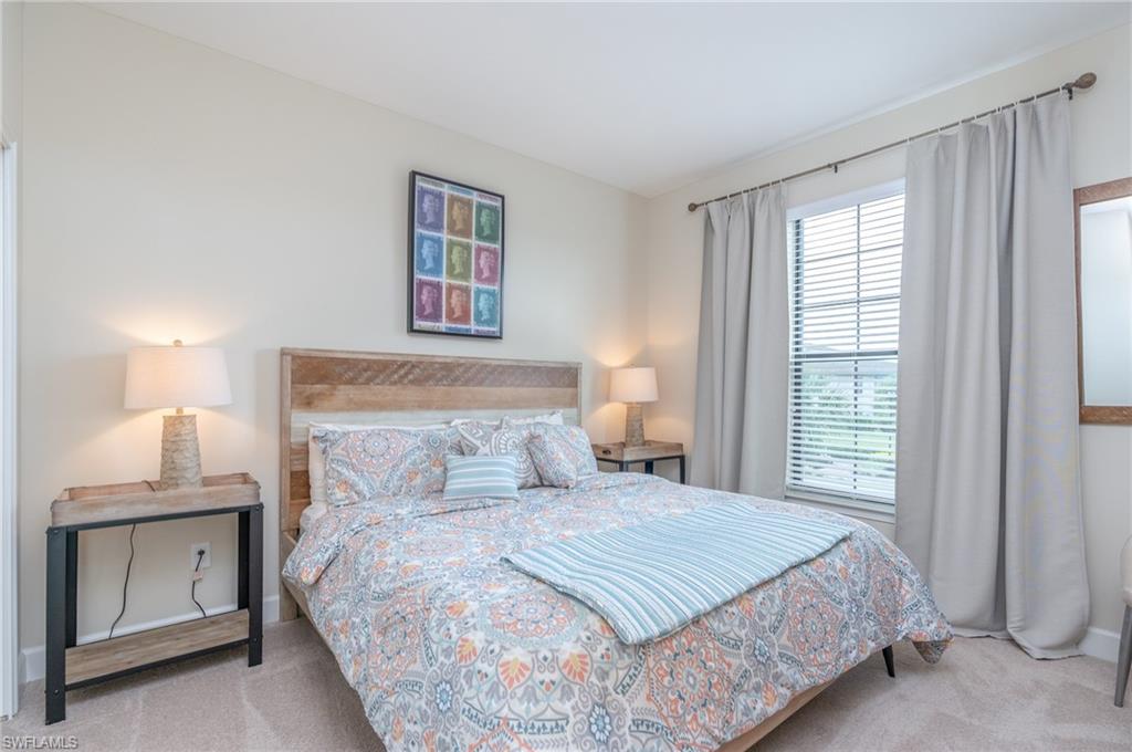 Bedroom with light carpet and baseboards