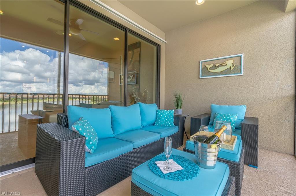 View of patio featuring an outdoor living space, a ceiling fan, and a water view