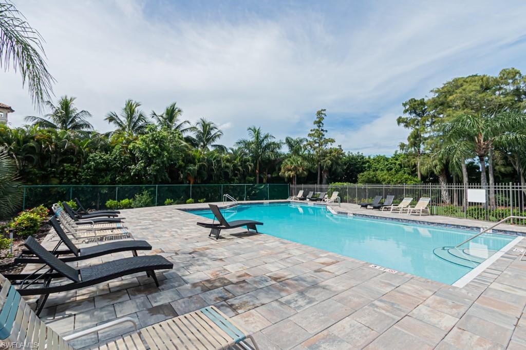 Community pool with a patio