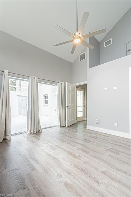 Unfurnished room featuring high vaulted ceiling, light wood finished floors, and ceiling fan