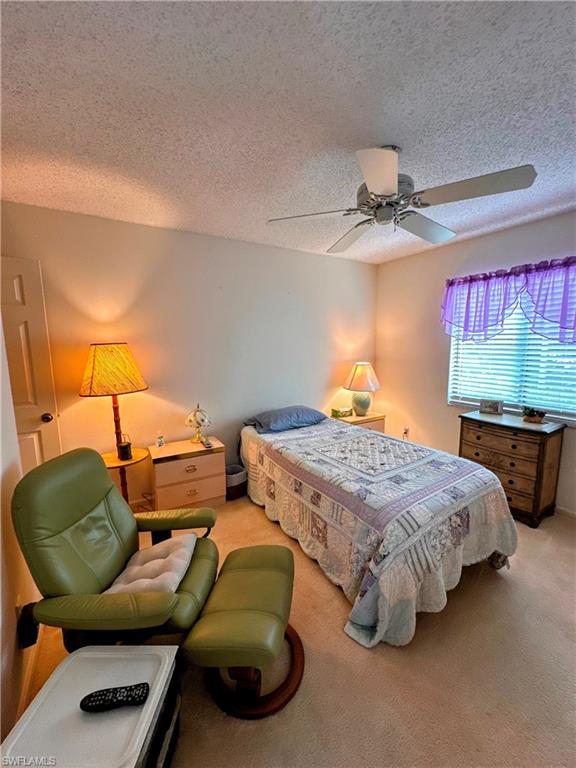 Bedroom featuring carpet, and a ceiling fan