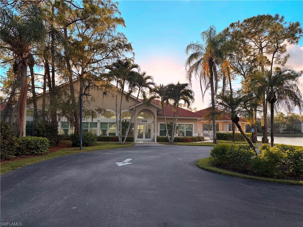 View of property featuring curved driveway