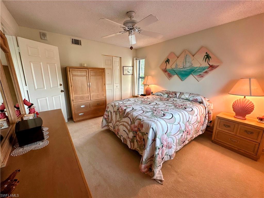 Large Bedroom with  a closet, light colored carpet, and a ceiling fan