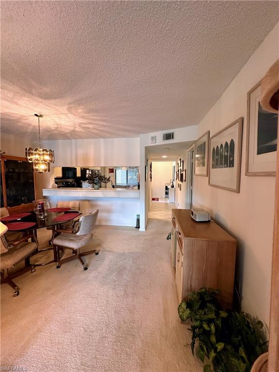 Dining room featuring a chandelier, and light colored carpet