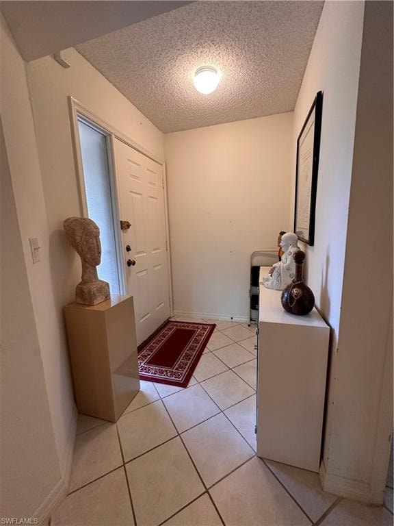 Entrance foyer featuring light tile patterned floors
