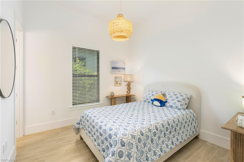 Bedroom featuring wood tiled floors and baseboards