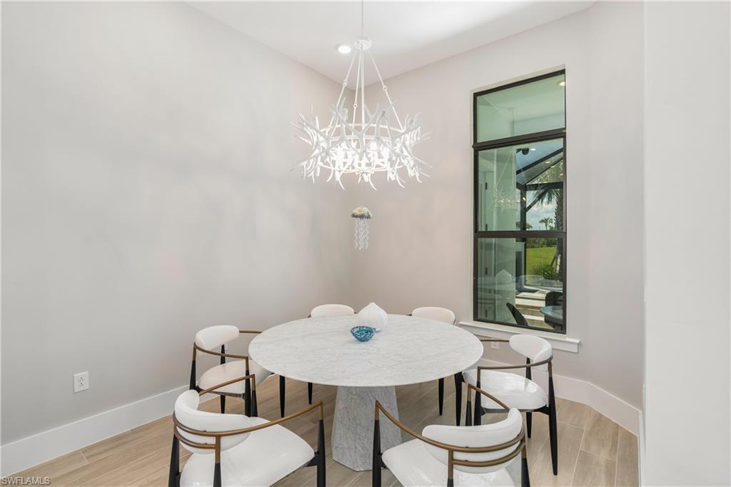Dining space featuring wood tiled floors and a chandelier