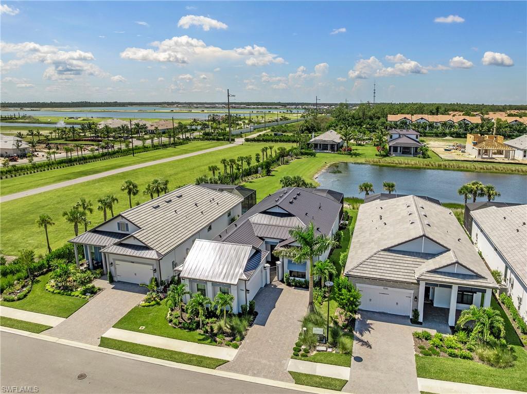 Aerial view of residential area featuring a nearby body of water