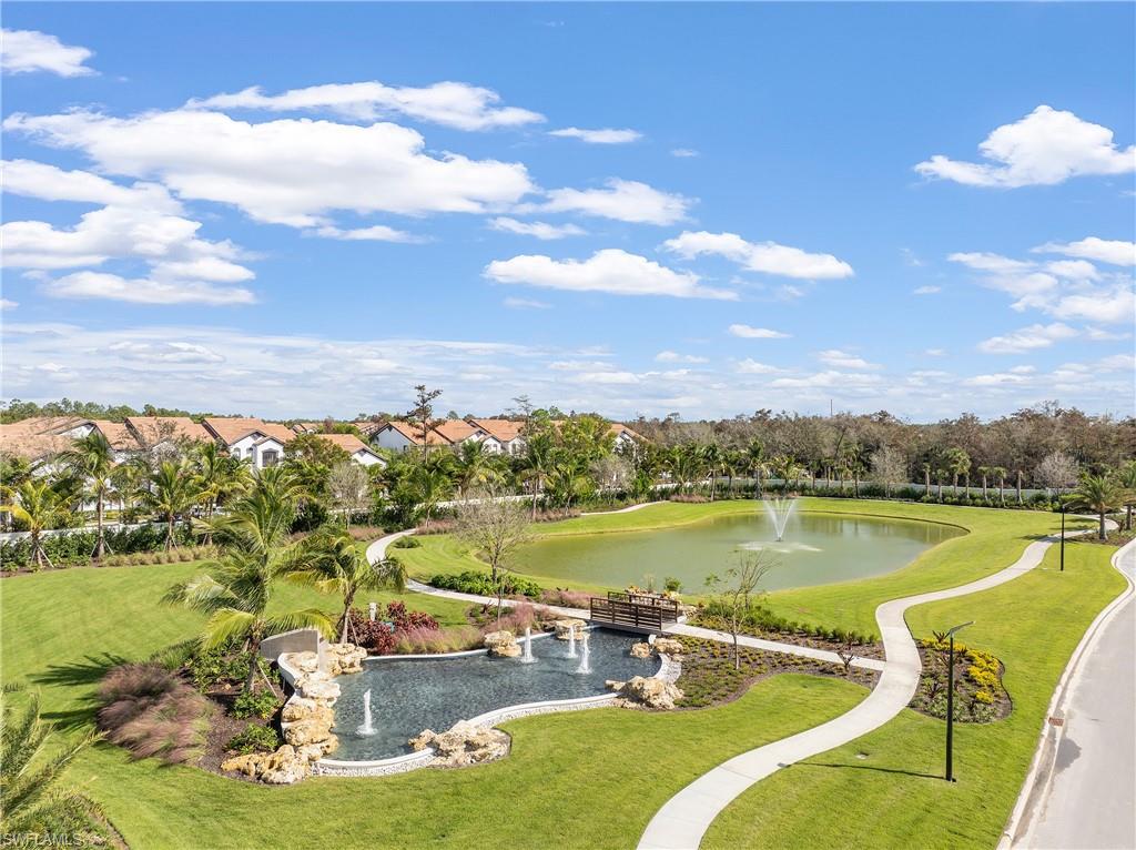 View of property's community featuring a water view and a lawn