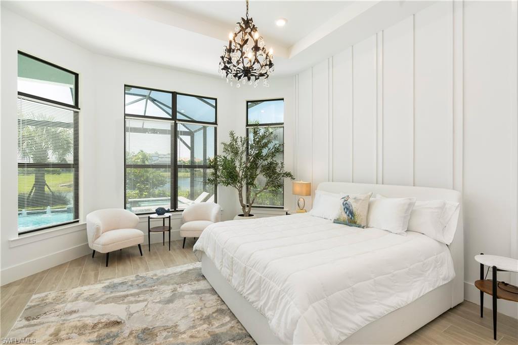 Bedroom featuring wood tiled floors, a chandelier, and recessed lighting