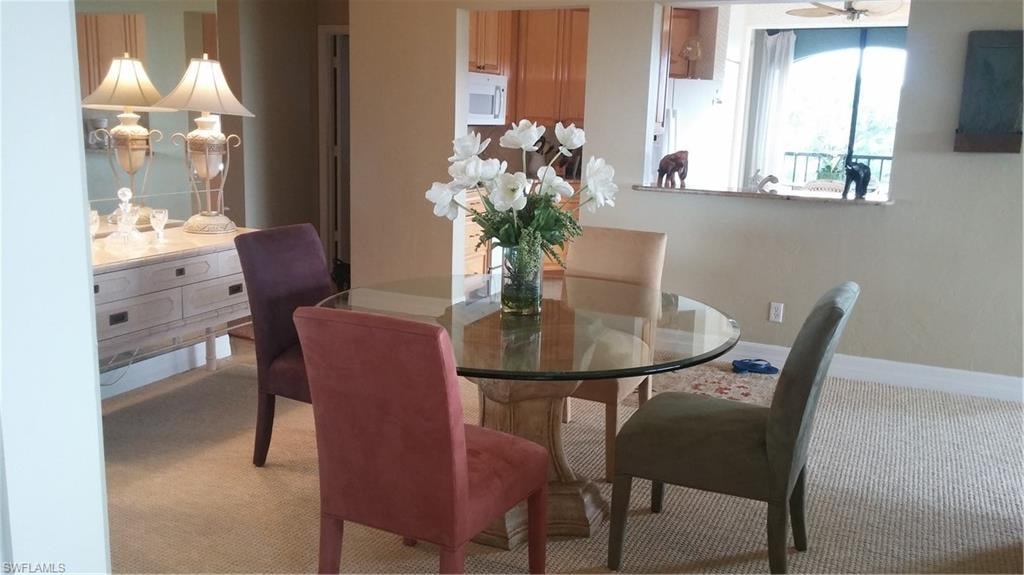 Dining space with carpet floors and baseboards