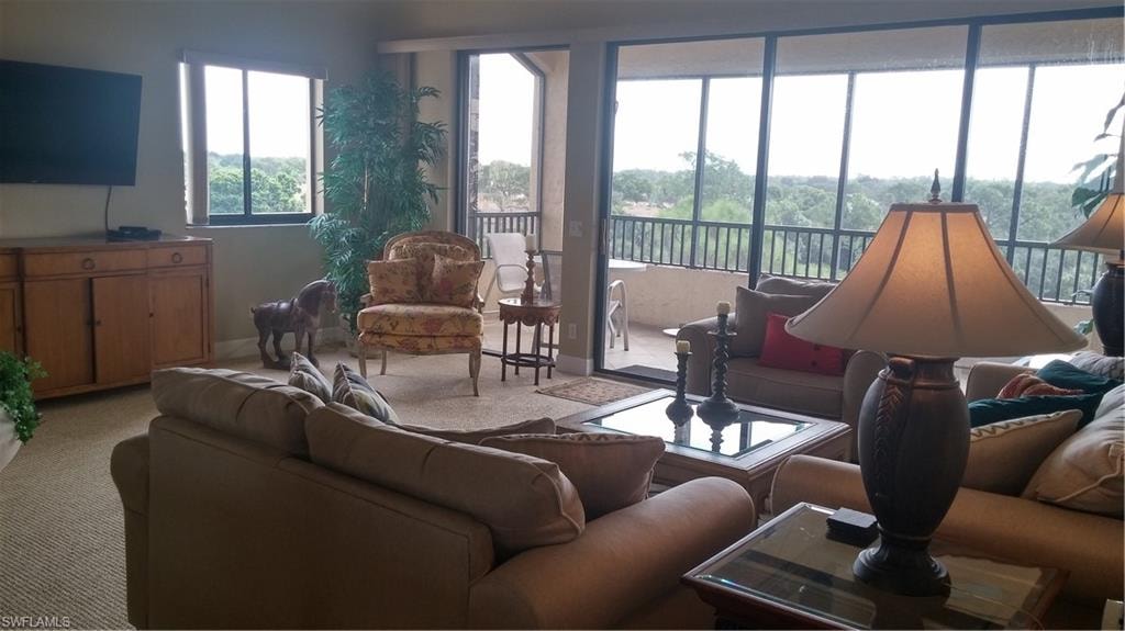 Carpeted living room featuring baseboards